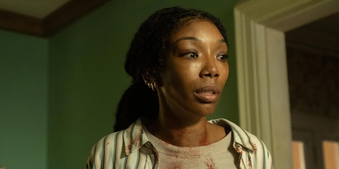 Brandy Norwood looking scared with blood stains on her clothes in 'The Front Room'.