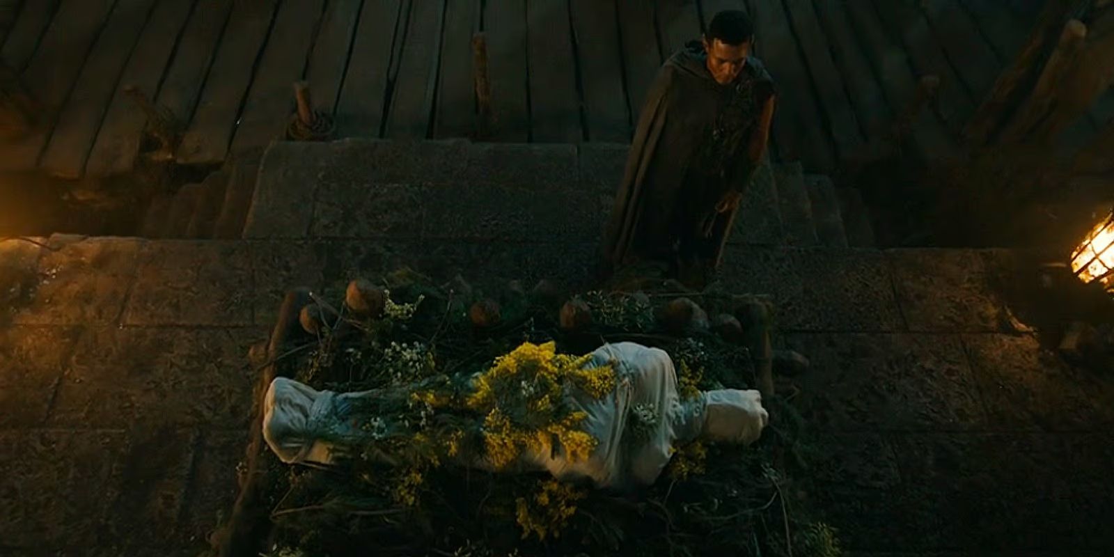 Arondir (Ismael Cruz Córdova) by Bronwyn's (Nazanin Boniadi) funeral pyre in Lord of the Rings: The Rings of Power