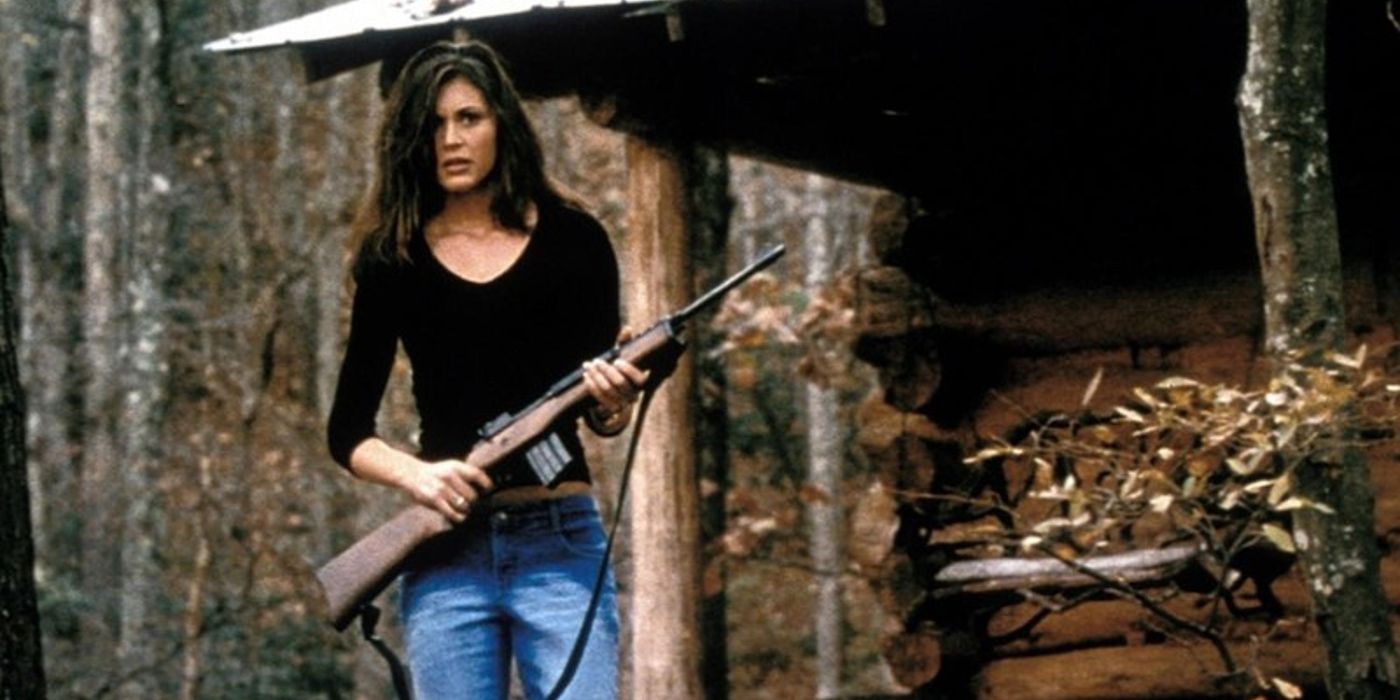 Marcy, played by actor Cerina Vincent, stands outside holding a rifle in Cabin Fever.