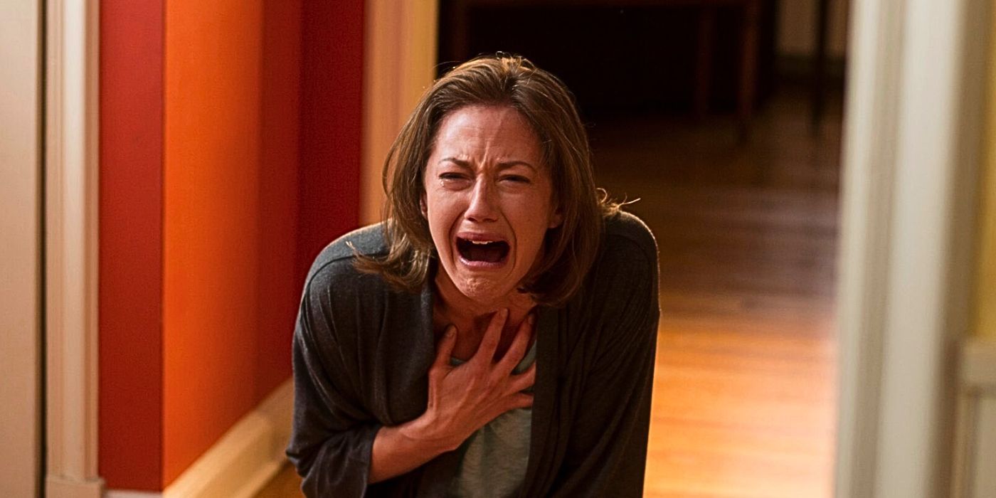 Carrie Coon clutches her heart after falling to her knees as she weeps in anguish in The Leftovers.