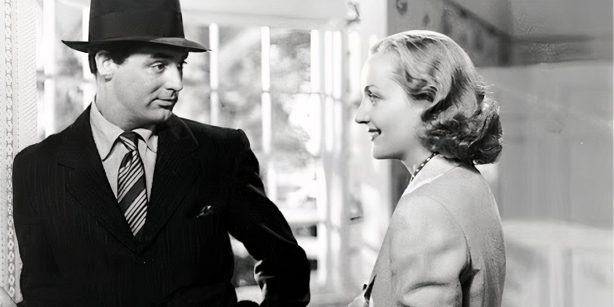 Cary Grant looking at Carole Lombard standing across from him in In Name Only (1939)