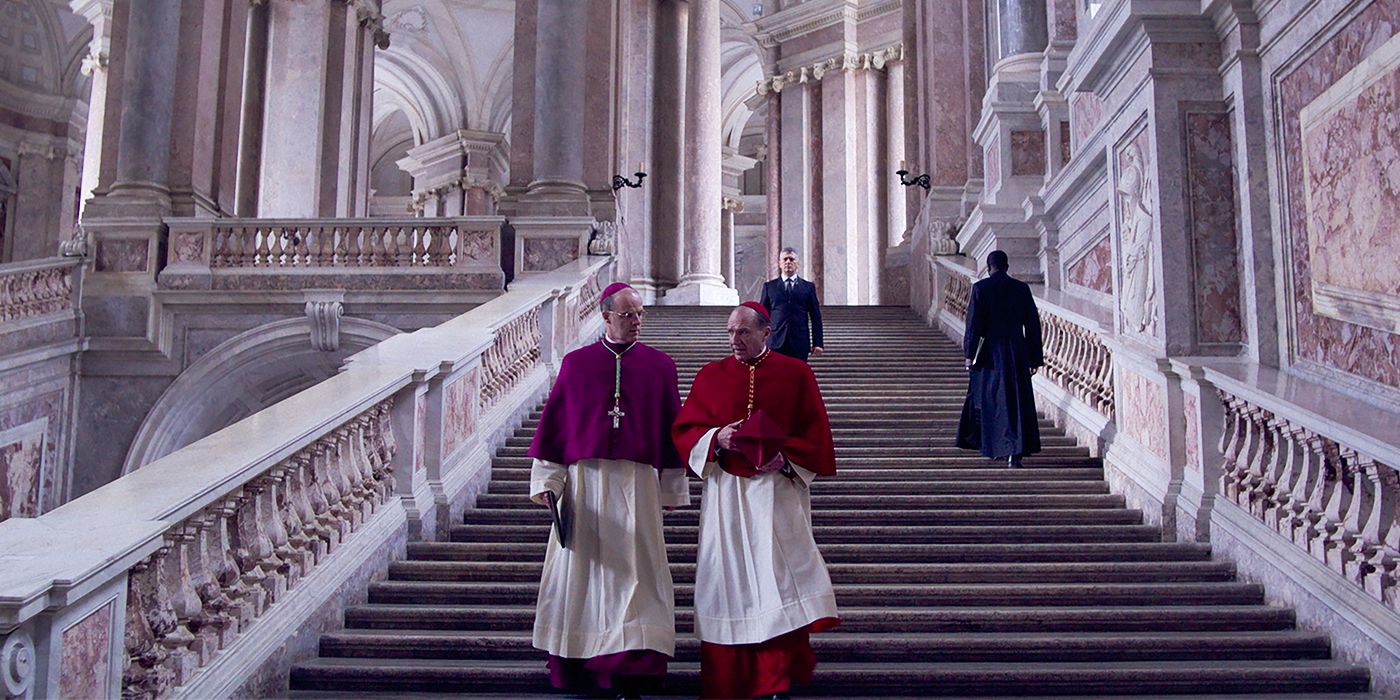 Brian F. O'Byrne and Ralph Fiennes descending marble stairs