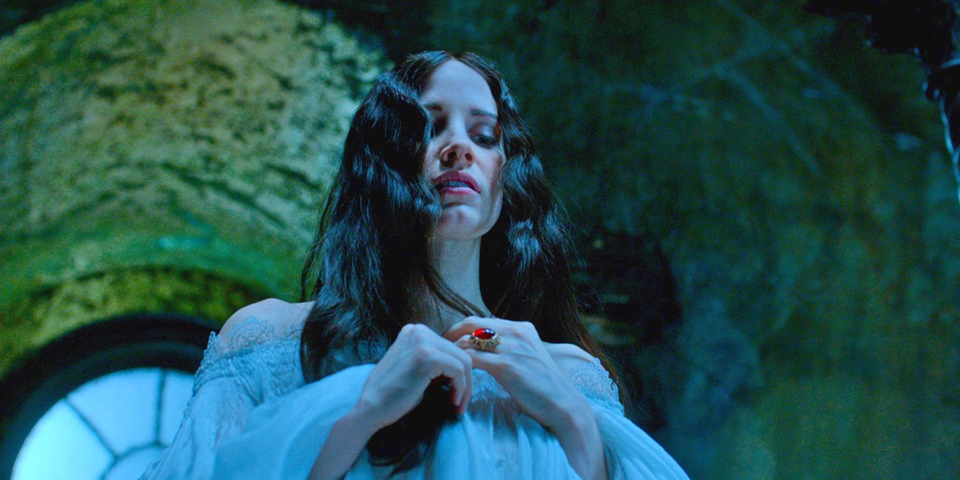 Lucille Sharp (Jessica Chastain) staring down in a white nightgown with her long dark hair down over her shoulders in Crimson Peak