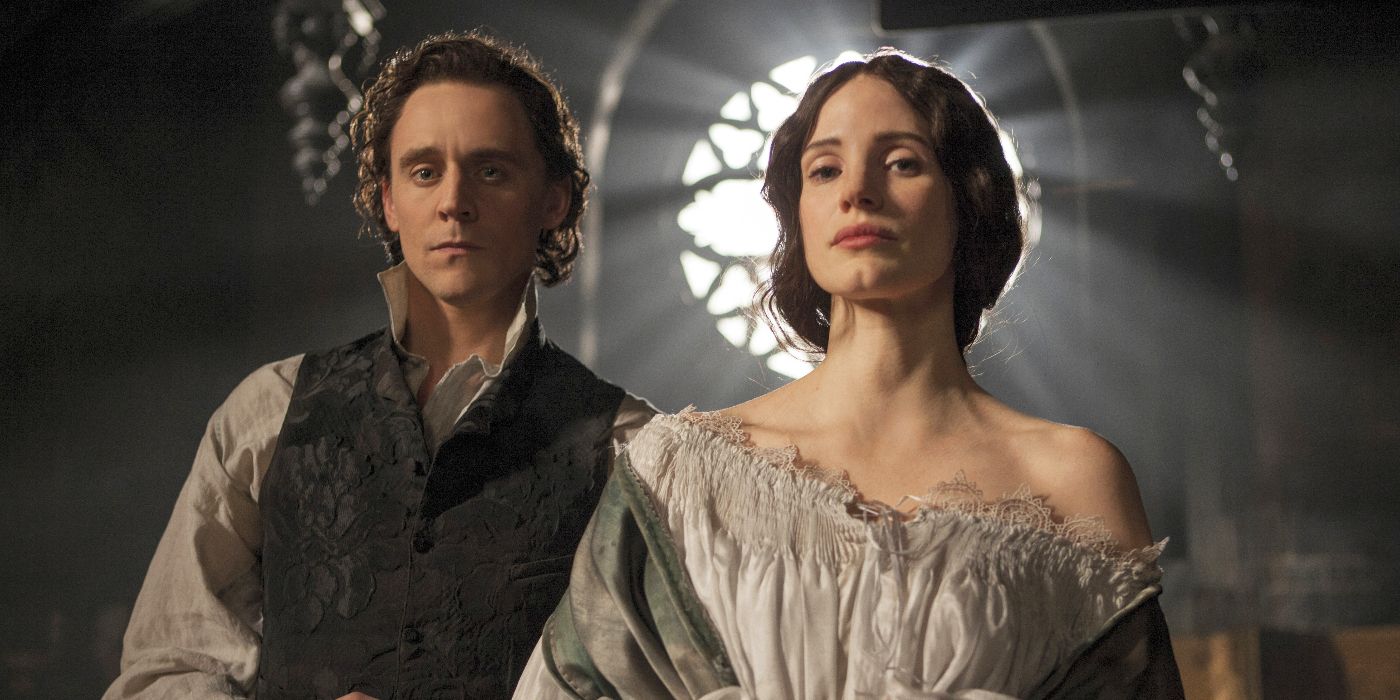 Thomas Sharpe (Tom Hiddleston) and Lucille (Jessica Chastain) stand close, facing forward in Crimson Peak