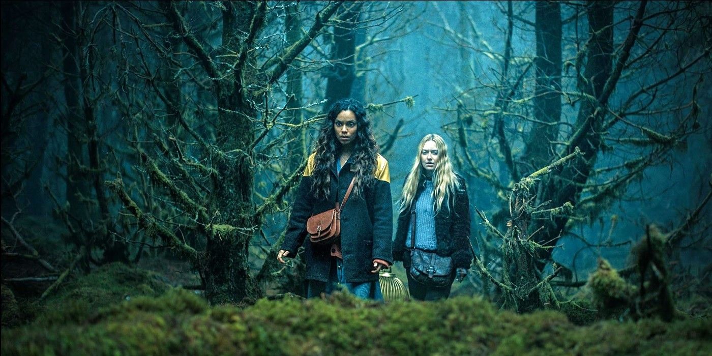 Georgina Campbell and Dakota Fanning walk through a dark forest in The Watchers (2024)