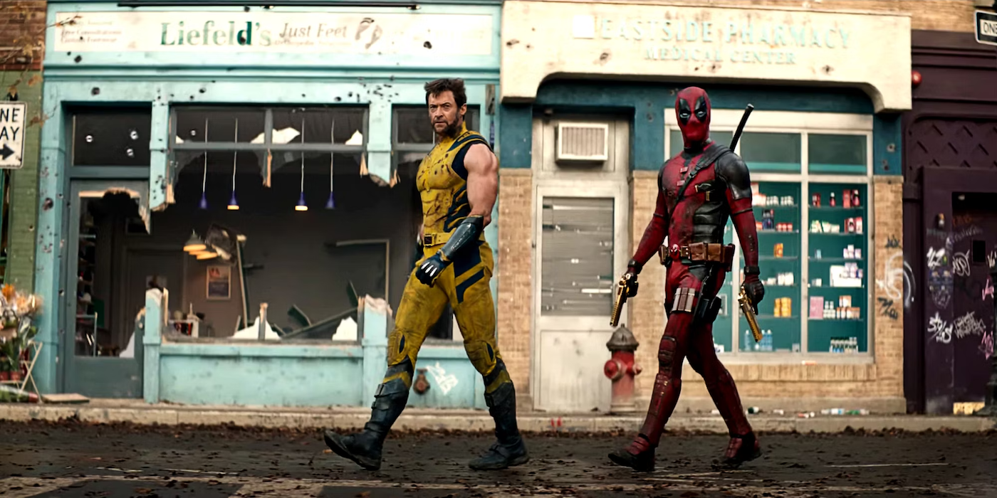 Deadpool & Wolverine walking down a destroyed street.