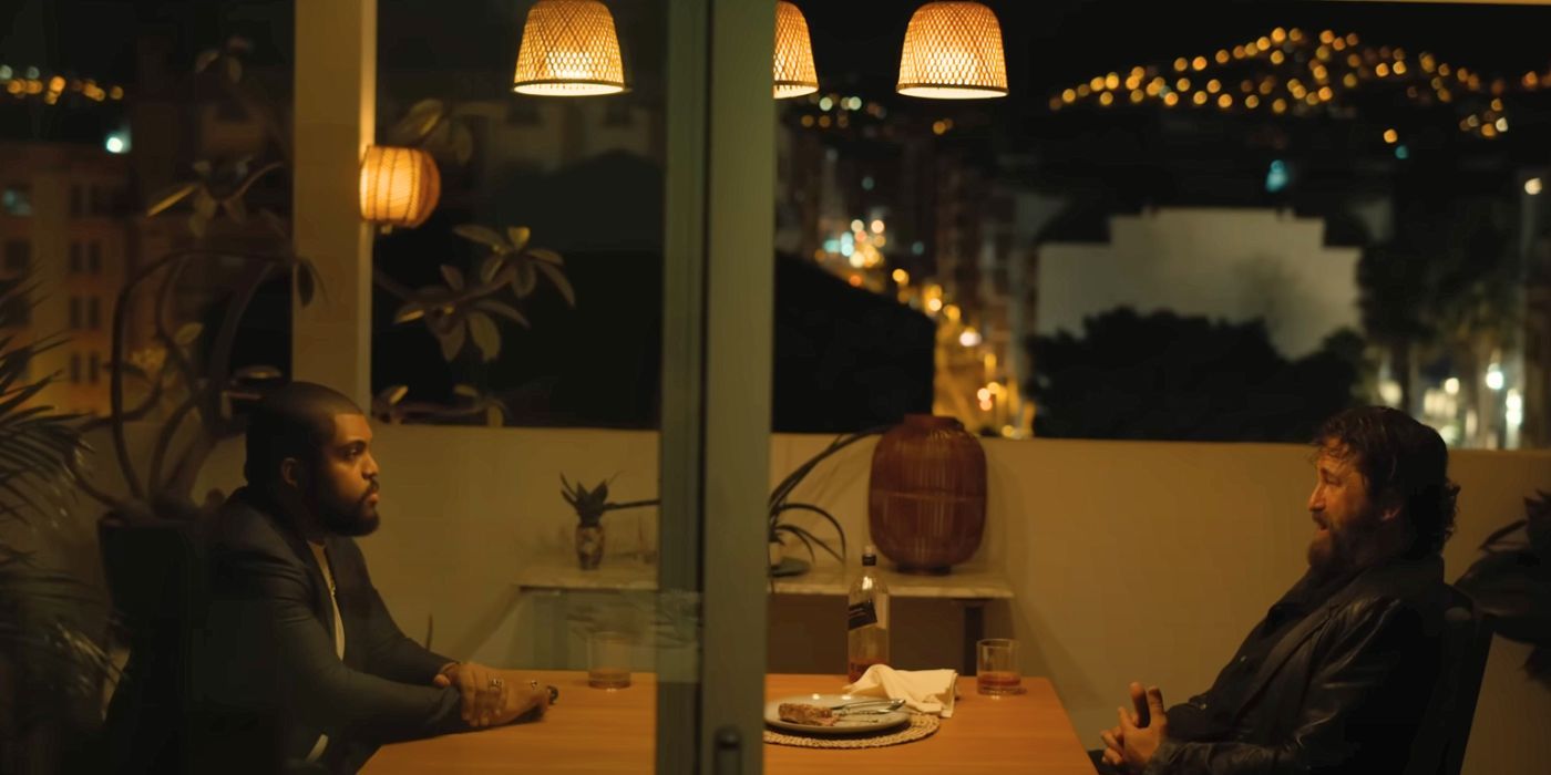 O&rsquo;Shea Jackson Jr. and Gerard Butler sitting across from each other at a table in Den of Thieves 2: Pantera.