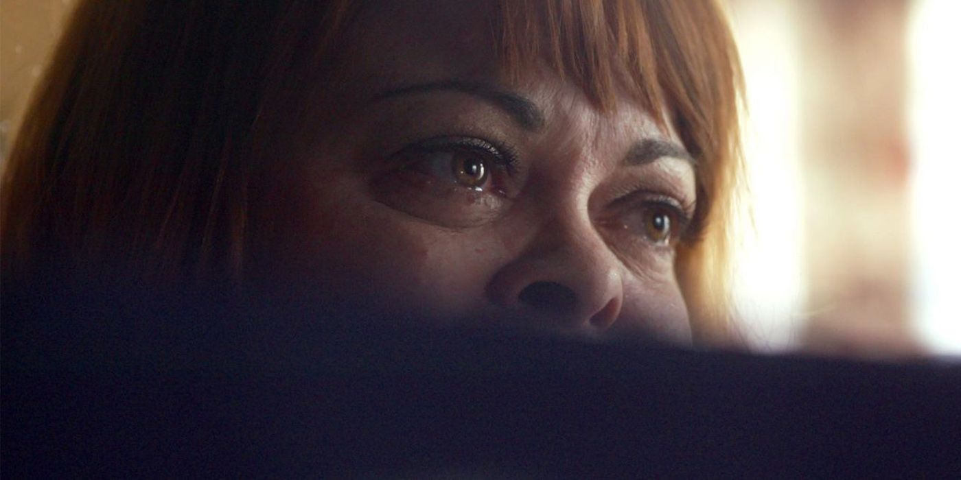 A close-up of a woman's eyes looking troubled while seeing a computer screen out of view in Don't F**k With Cats.