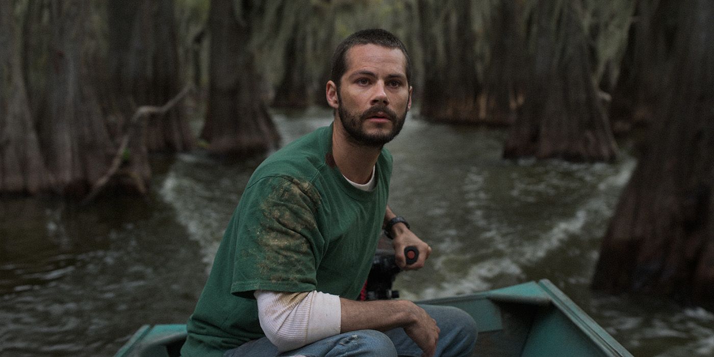 Dylan O'Brien driving a small boat with a motor in a swamp in Caddo Lake 