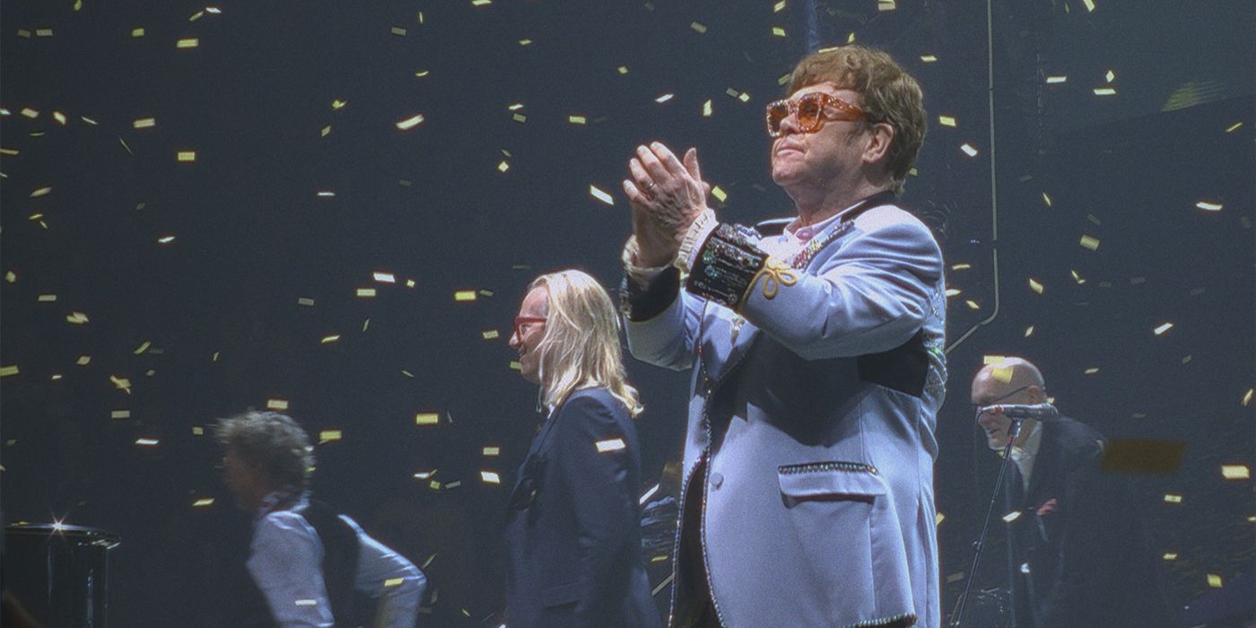 Elton John on stage clapping at his farewell Dodger Stadium concert