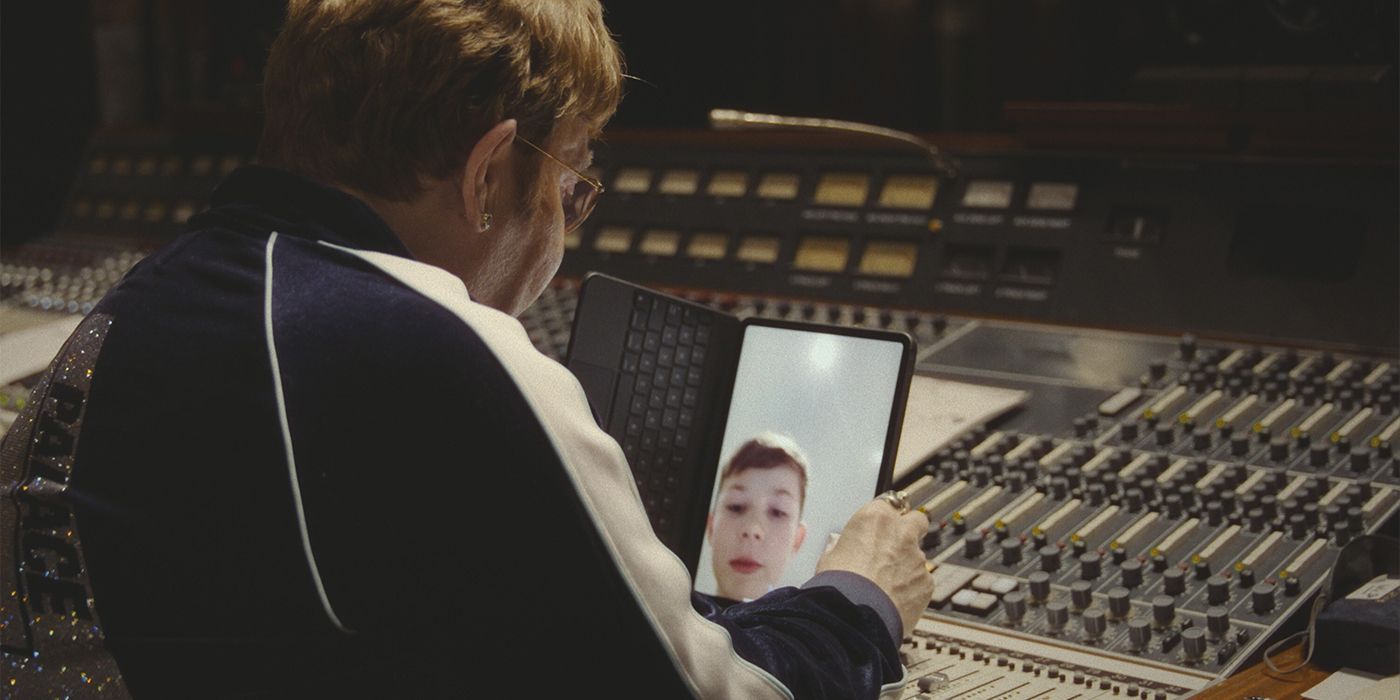 Elton John FaceTiming with his son over a music board in a studio