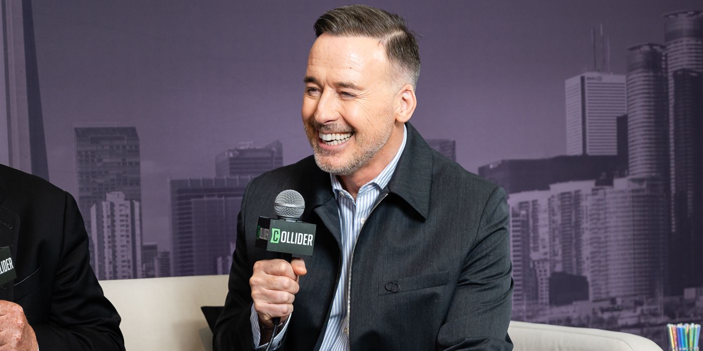 David Furnish smiling with his mic at TIFF 2024 for Elton John: Never Too Late