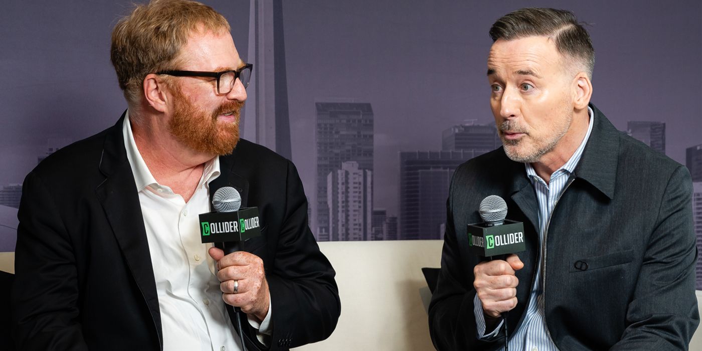 RJ Cutler and David Furnish sit holding mics at TIFF 2024 for Elton John: Never Too Late