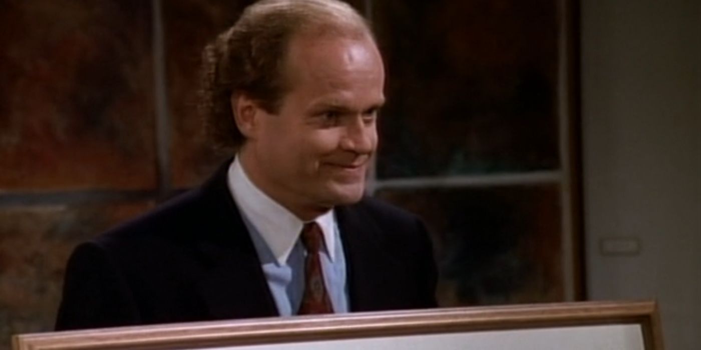 Frasier holds up the fraudulent art in his hands. He is looking directly at the art gallery owner.