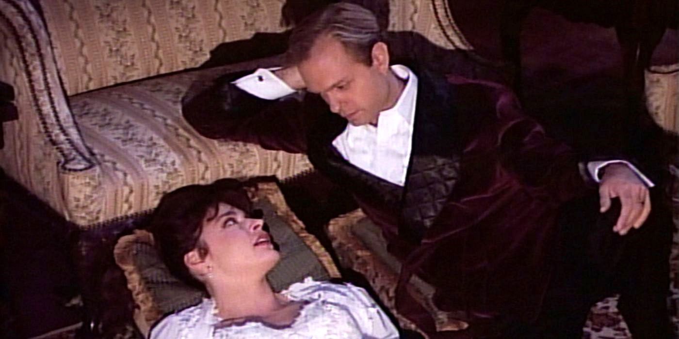 Niles and Daphne wear romantic outfits and look wistfully at each other as they recline on the floor in Frasier.
