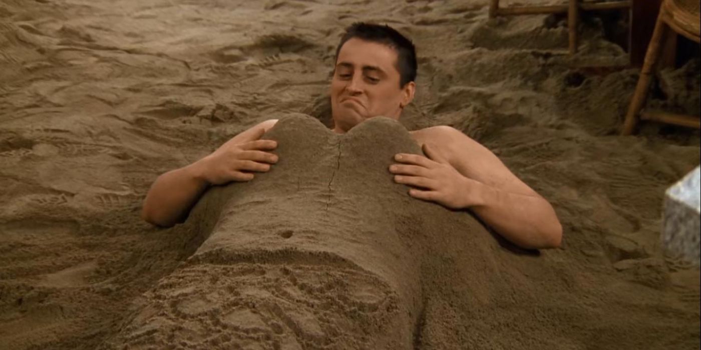 Joey, buried in sand, admires his sand mermaid body in Friends.