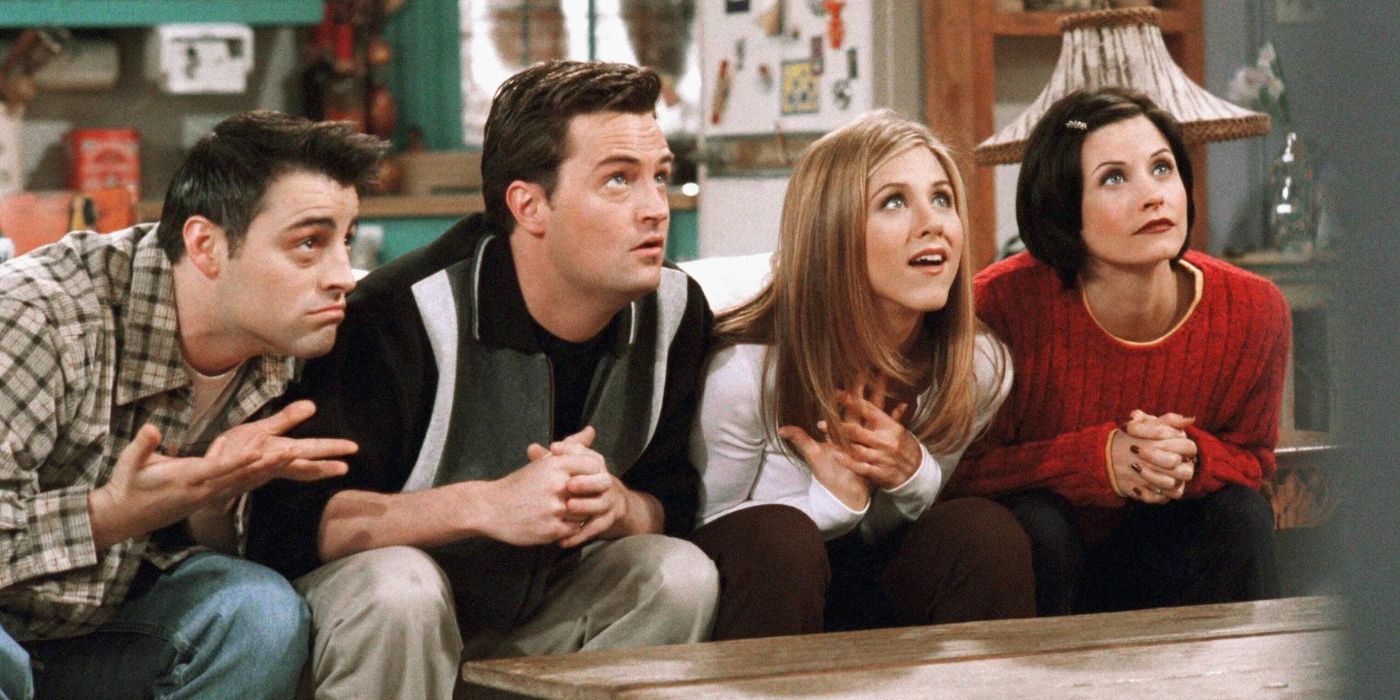 Joey, Chandler, Rachel, and Monica sit on the couch, leaning forward, ready to play trivia on Friends.