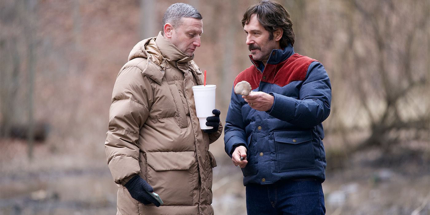 Paul Rudd holding up a mushroom and Tim Robinson holding a drink and looking at it