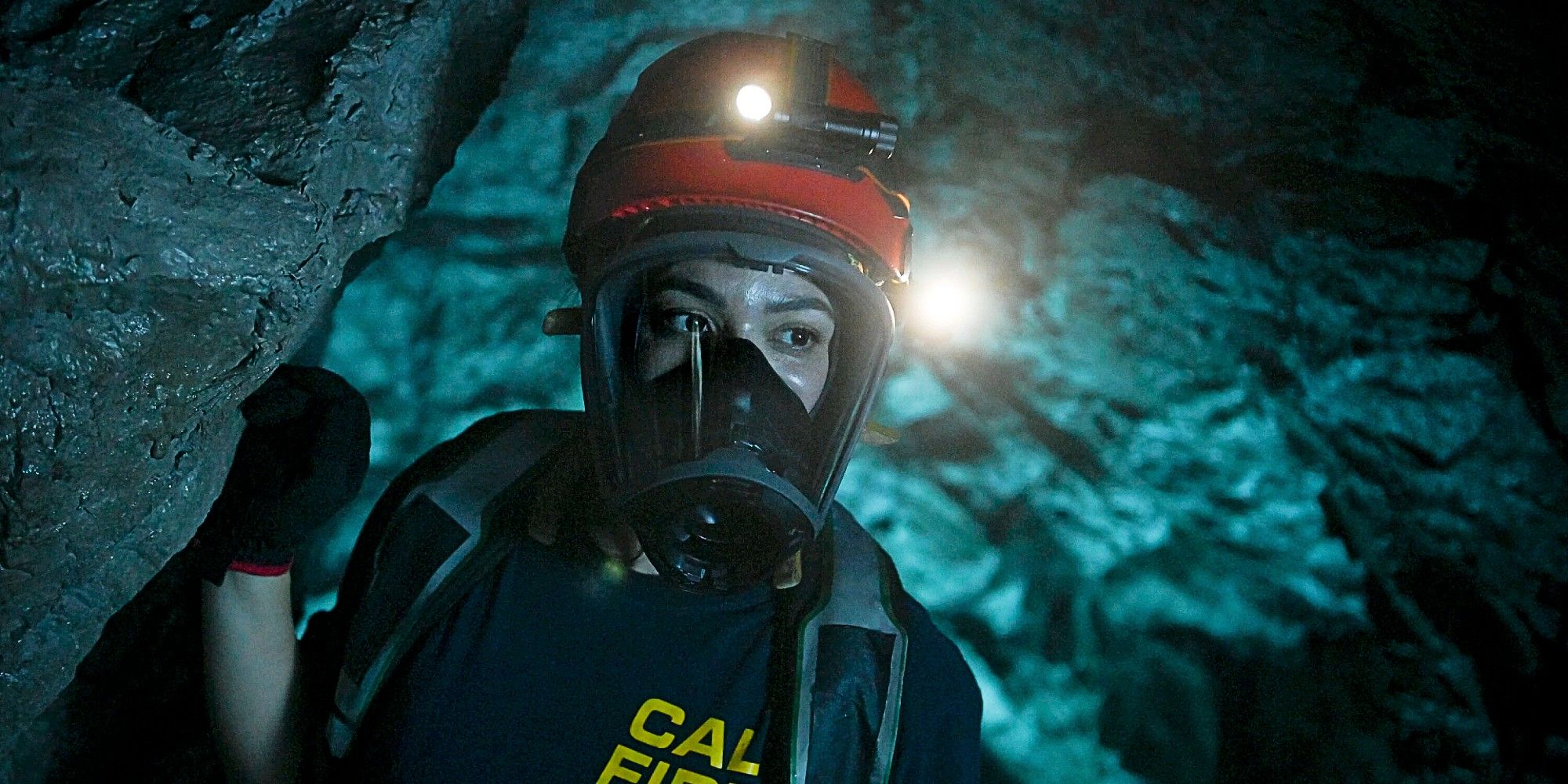 Gabriela Perez in an underground cave, wearing an oxygen mask, in Fire Country Season 2