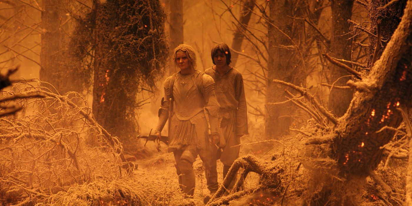 Galadriel wears armor and walks with Theo through a yellow wood in The Lord of the Rings: Rings of Power.