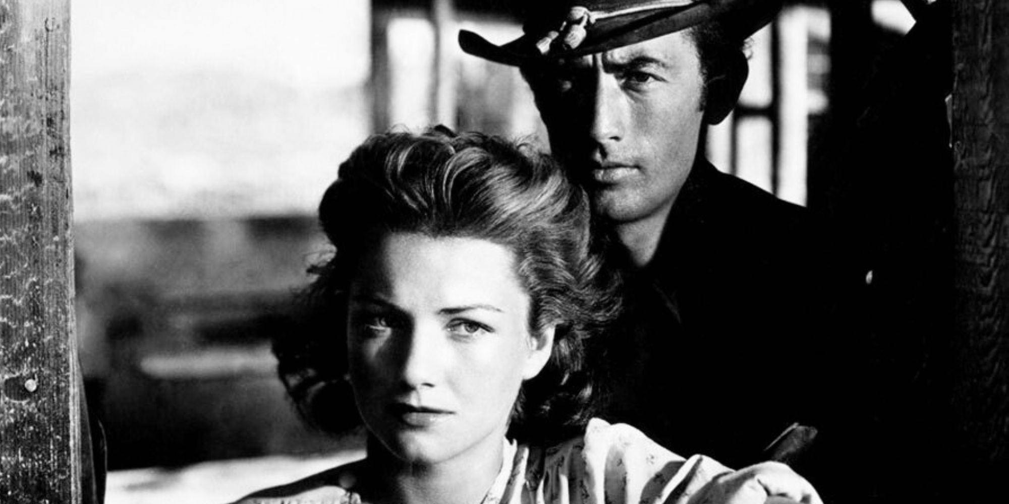Gregory Peck standing behind Anne Baxter in Yellow Sky (1948)