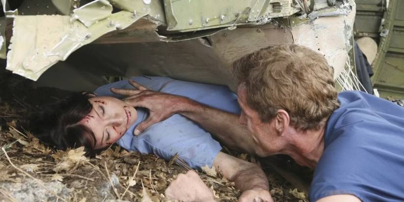 Mark Sloan (Eric Dane) tries to rescue Lexi Grey (Chyler Leigh) as she's trapped under a crashed plane in Grey's Anatomy