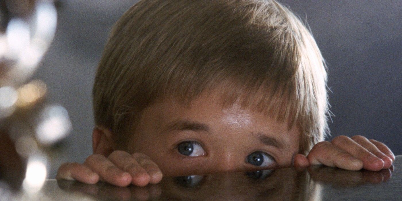 Haley Joel Osment looking from under a table in AI Artificial Intelligence