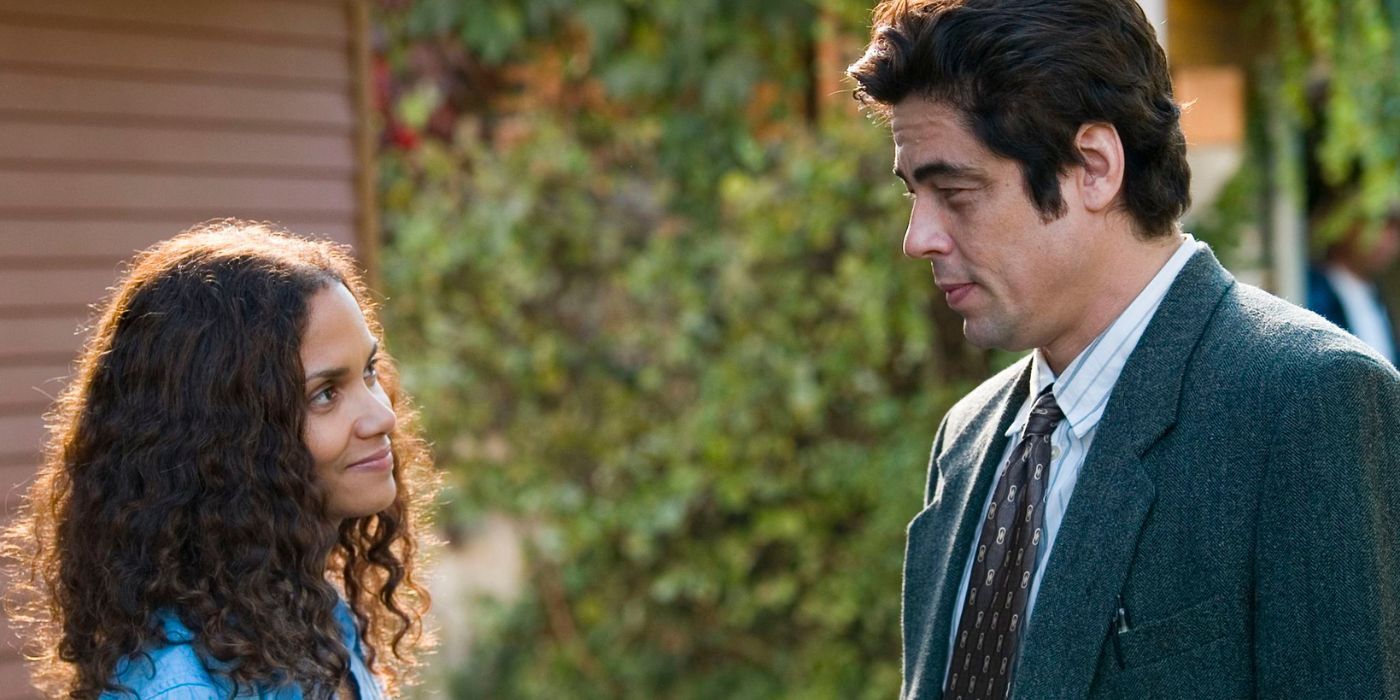 Halle Berry and Benicio Del Toro stand outside smiling at each other in Things We Lost in the Fire