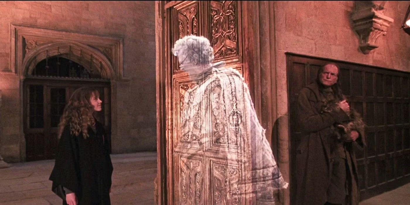 John Cleese as Nearly Headless Nick talking to Emma Watson as Hermione in Harry Potter and the Chamber of Secrets