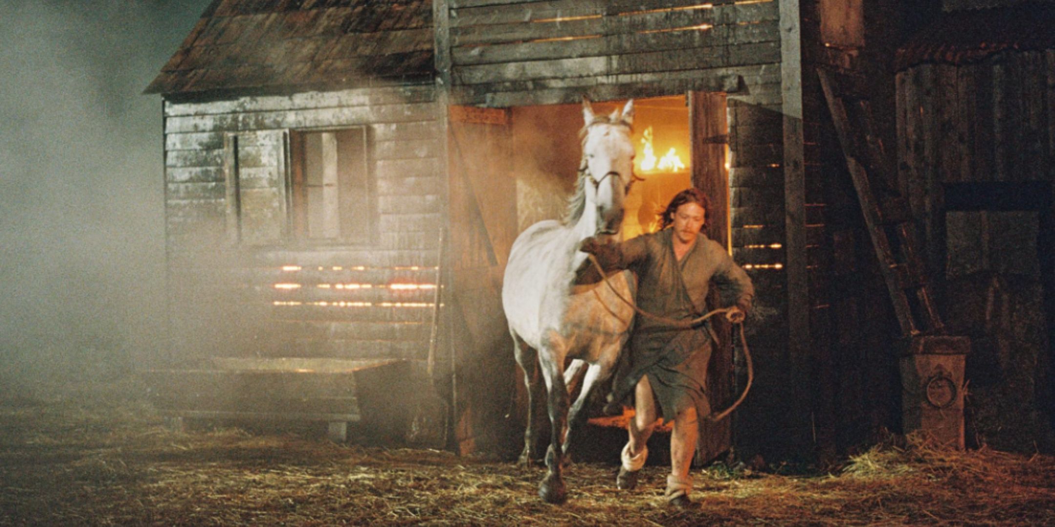 Caleb Landry Jones pulling horse out of burning shed in Harvest.