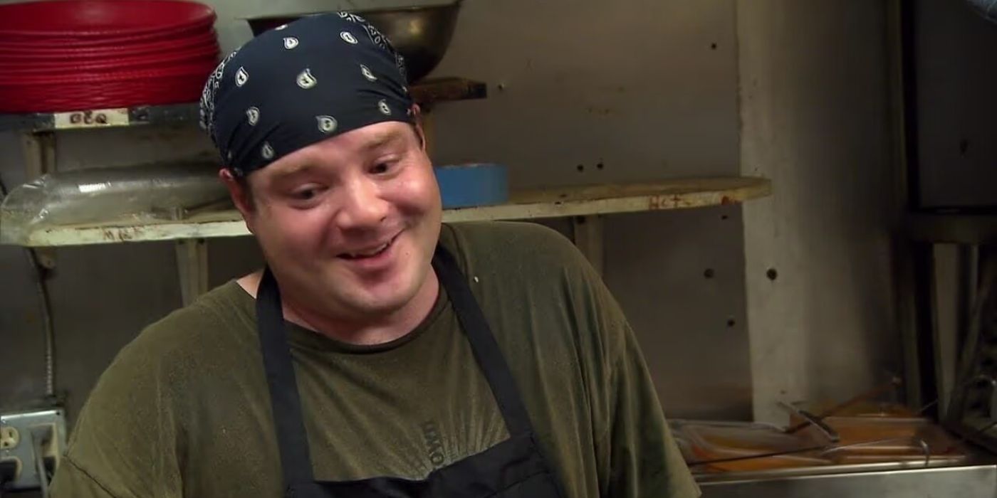 Chef from the episode &lsquo;Hole in None&rsquo; smiles with a bandana on, on Bar Rescue