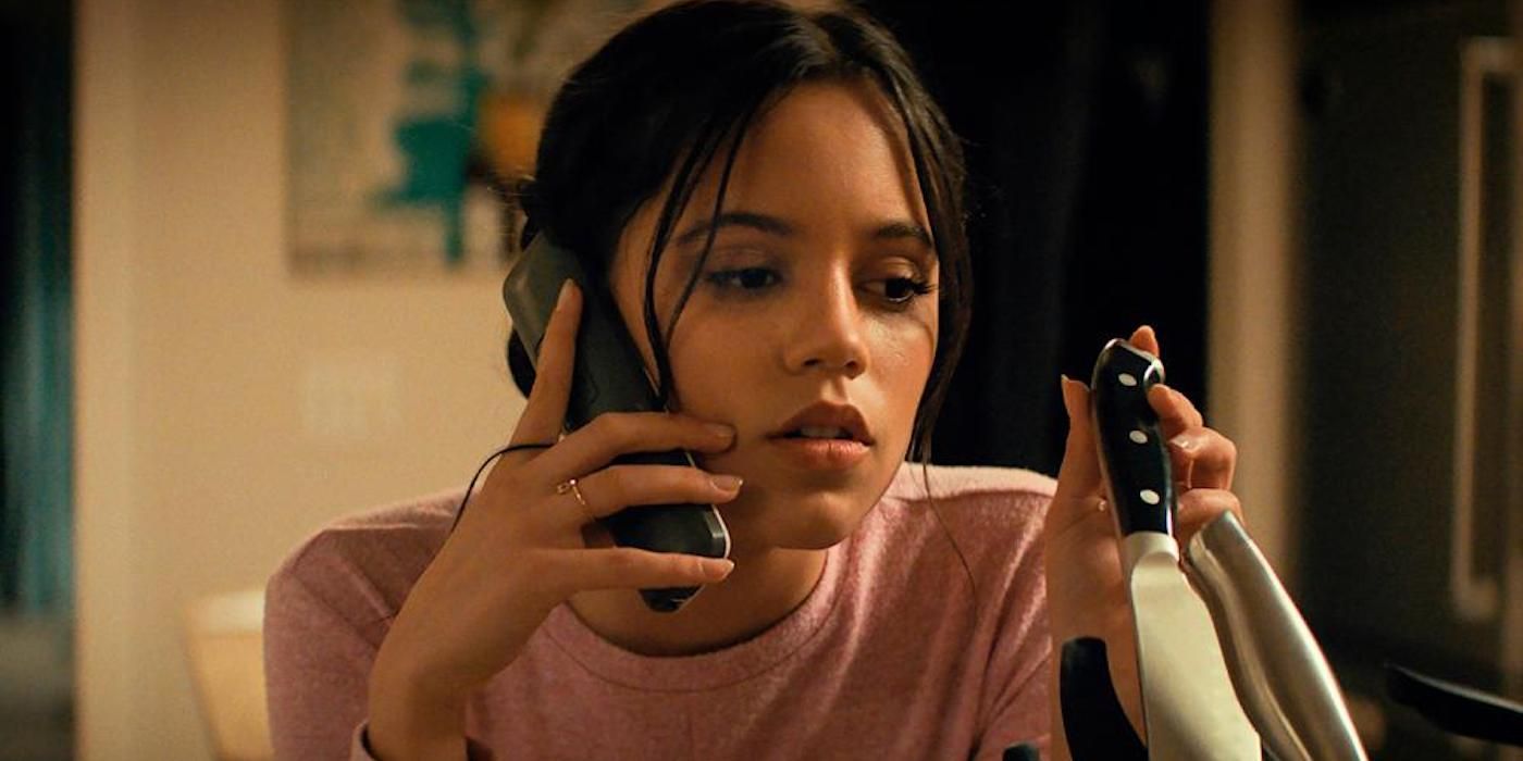 Jenna Ortega plays with a knife block while on the phone in Scream 2022