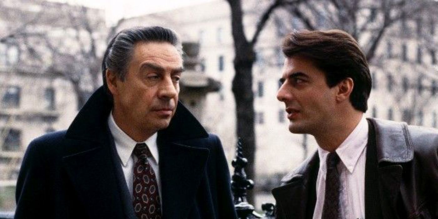 Jerry Orbach and Chris Noth look at each other outdoors on a street in Law & Order.