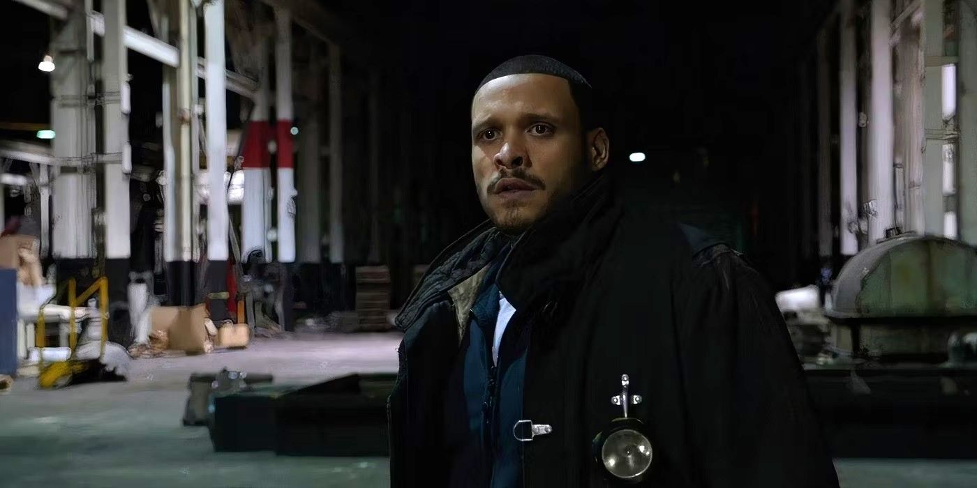 Joe Minoso as Joe Cruz in bunker gear stands in the middle of an abandoned building in Chicago Fire.