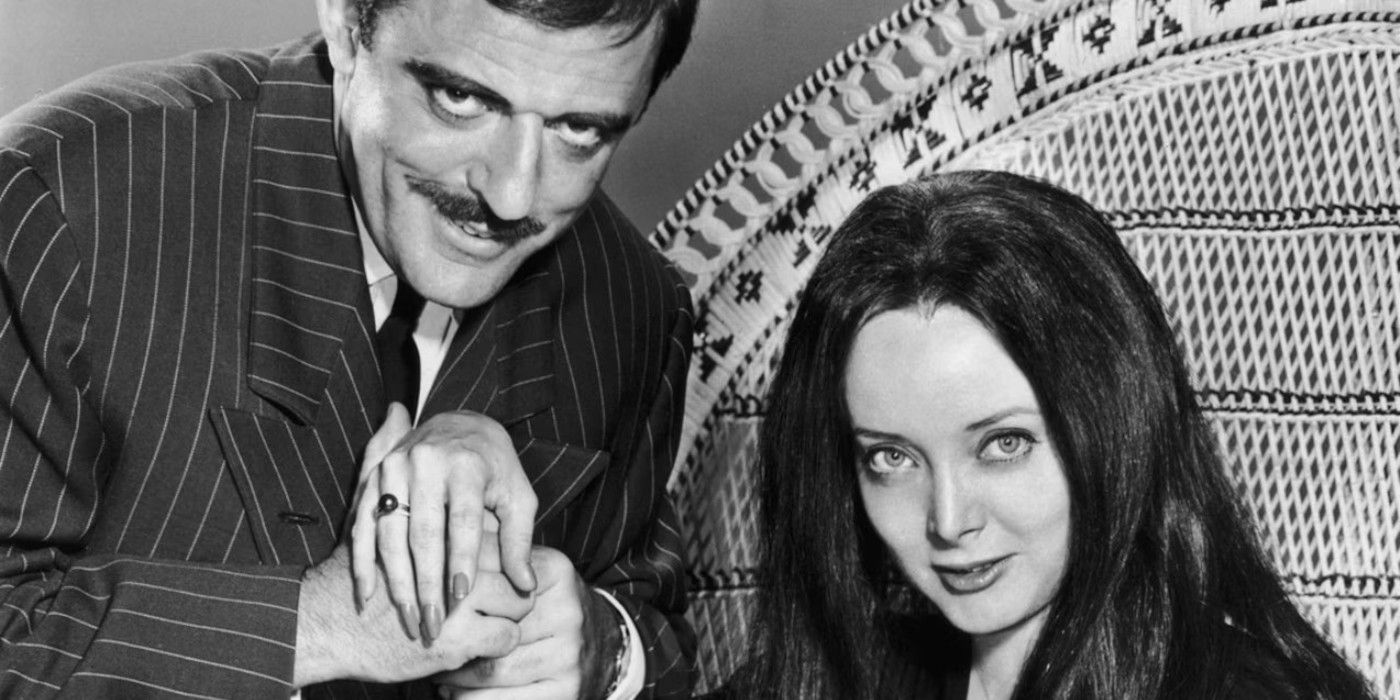 Gomez Addams holds Morticia's hand in The Addams Family