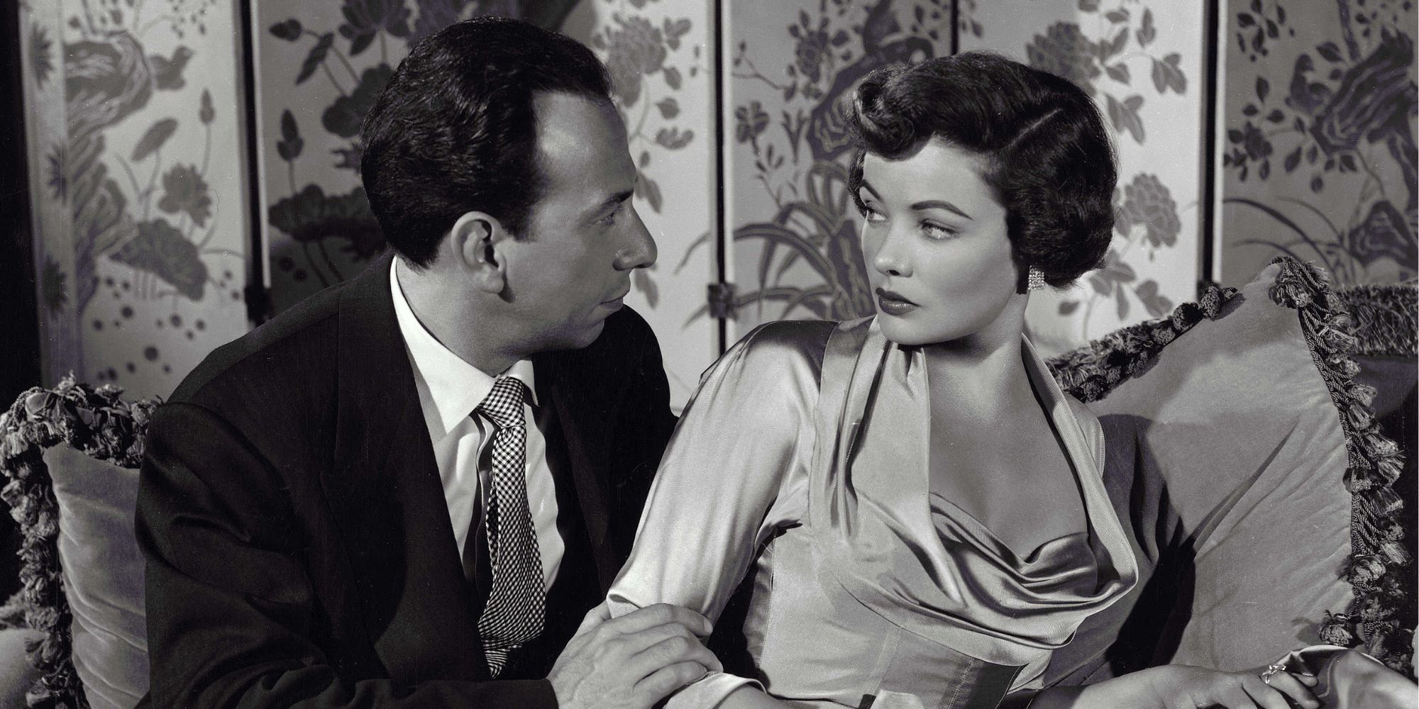 José Ferrer sitting next to Gene Tierney both looking at each other in Whirlpool (1950)