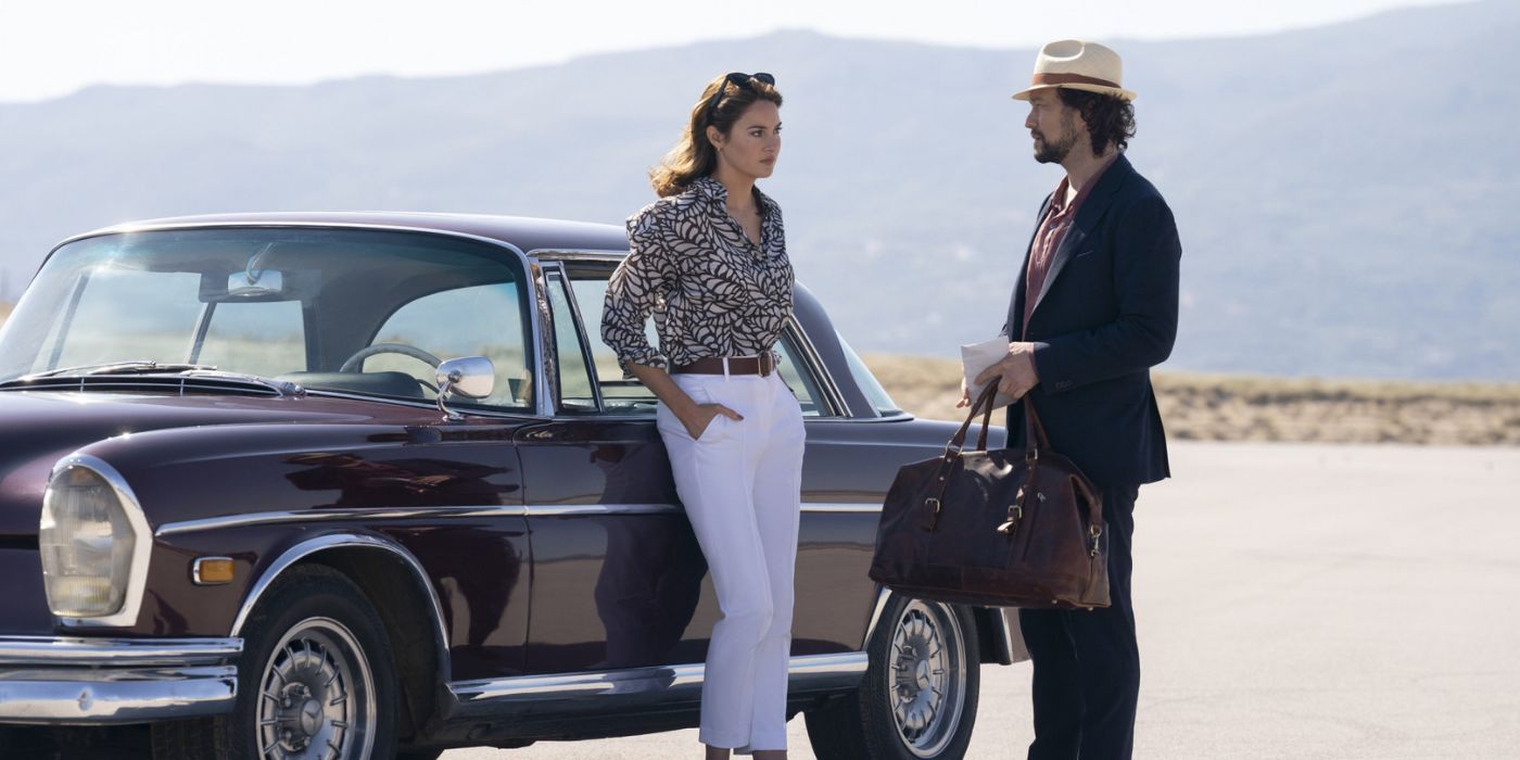 Shailene Woodley leaning on a vintage car in the desrt while talking to a fedora-clad Joseph Gordon-Levitt.