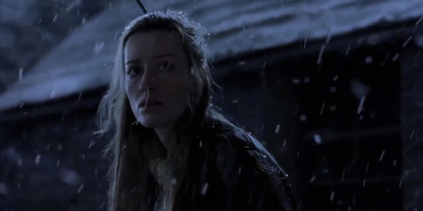Deborah (Natascha McElhone), a young woman, stands outside on a snowy night in &lsquo;Killing Me Softly&rsquo; (2022).