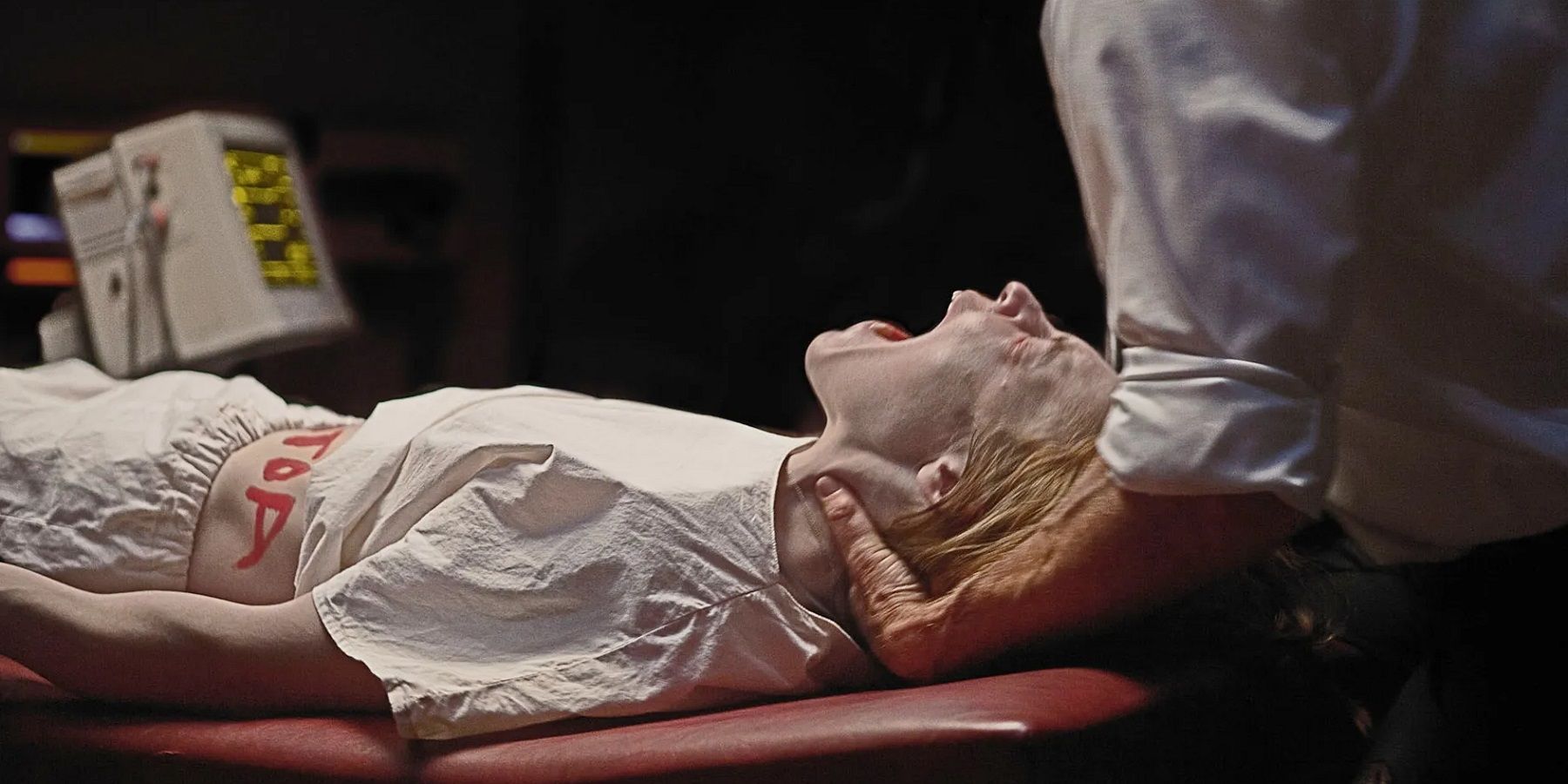 Ashley Bell as Nell lying down and screaming in pain in The Last Exorcism Part 2