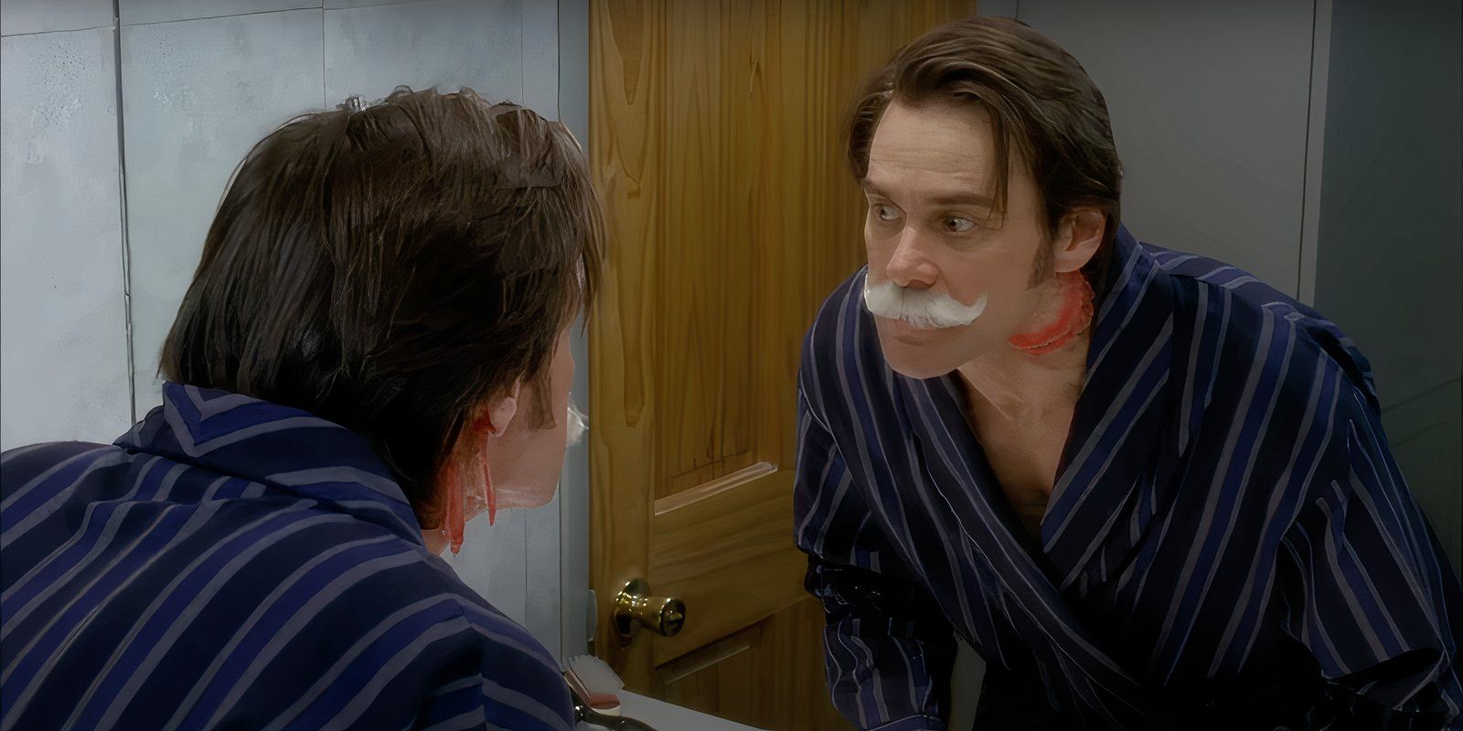 Jim Carrey looks in a mirror with a white mustache in the fake movie Leap Dave Williams on 30 Rock.