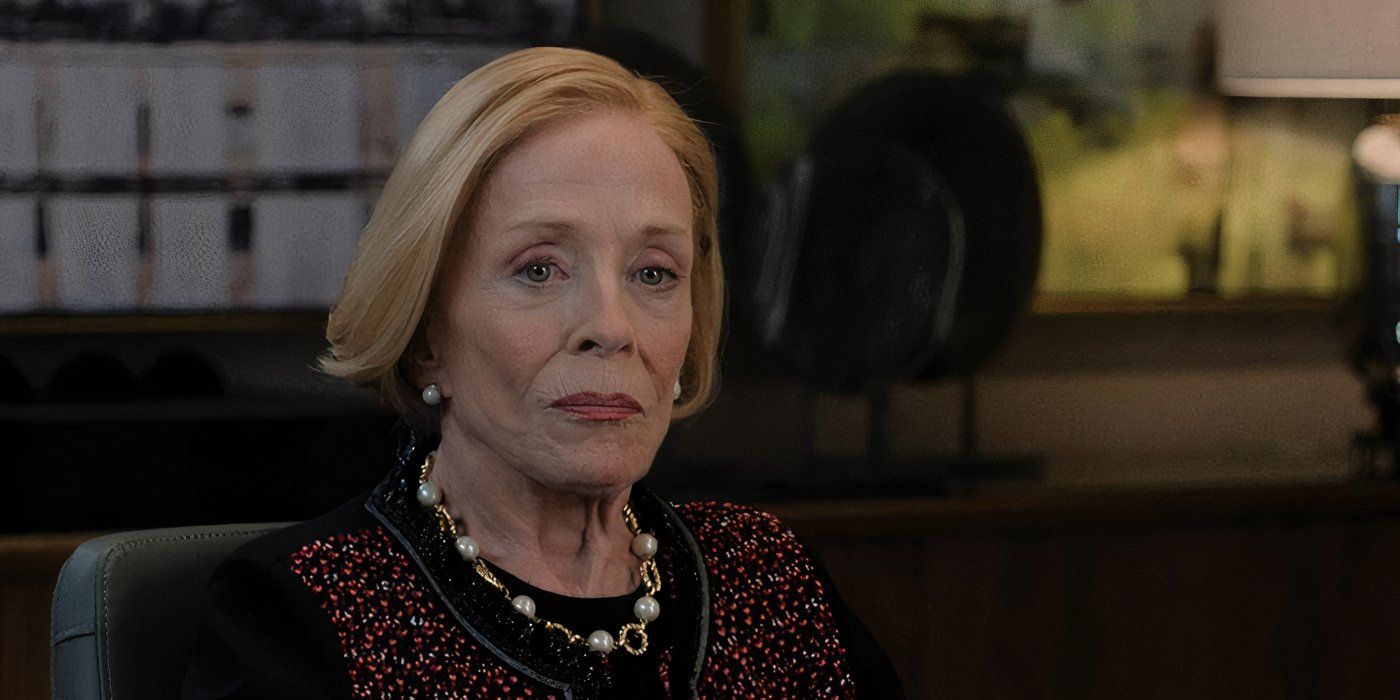 holland taylor in a jazzy shirt with a necklace and pearl earrings