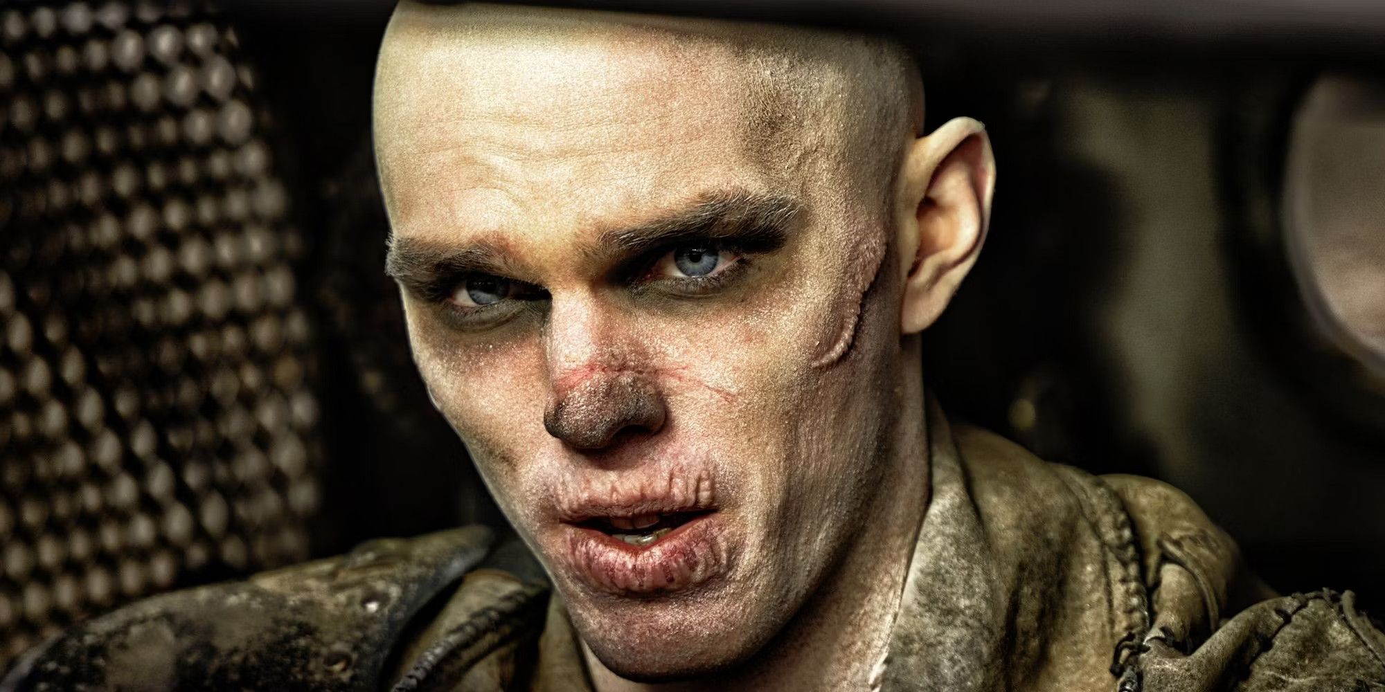 Nicholas Hoult as Nux looking intently at something in Mad Max: Fury Road.