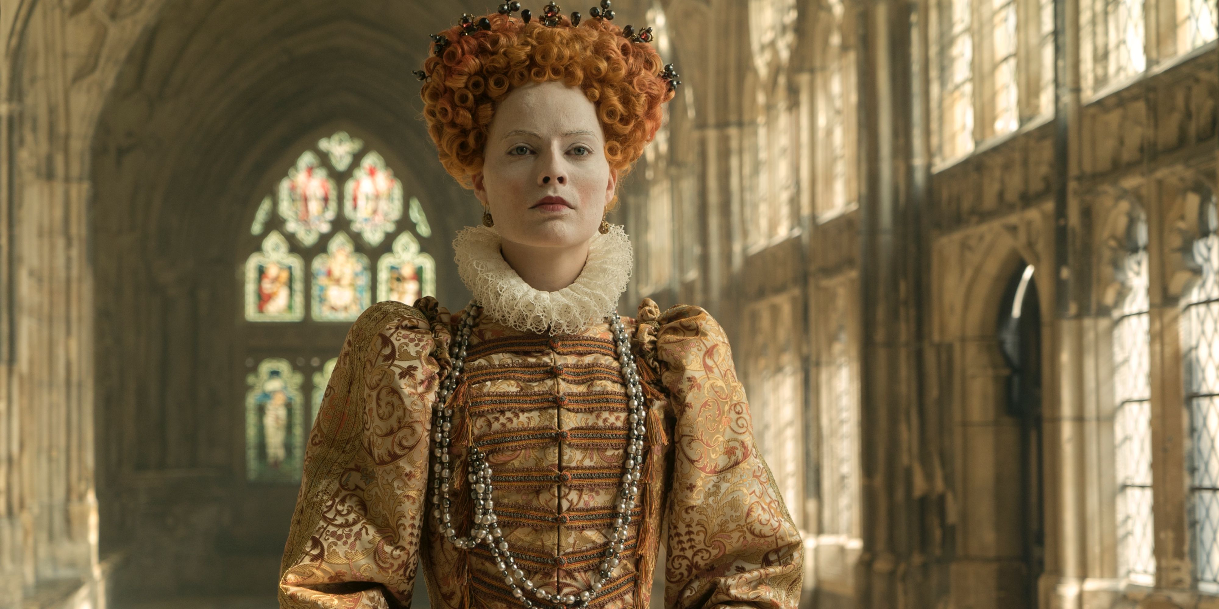 Margot Robbie as Elizabeth I in a church in 'Mary Queen of Scots'