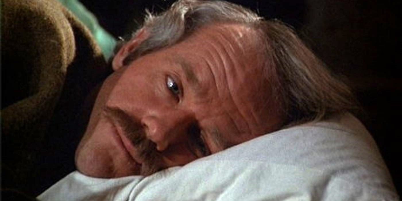 A man lays his head on a pillow and looks forlorn in M<em>A</em>S<em>H</em>.