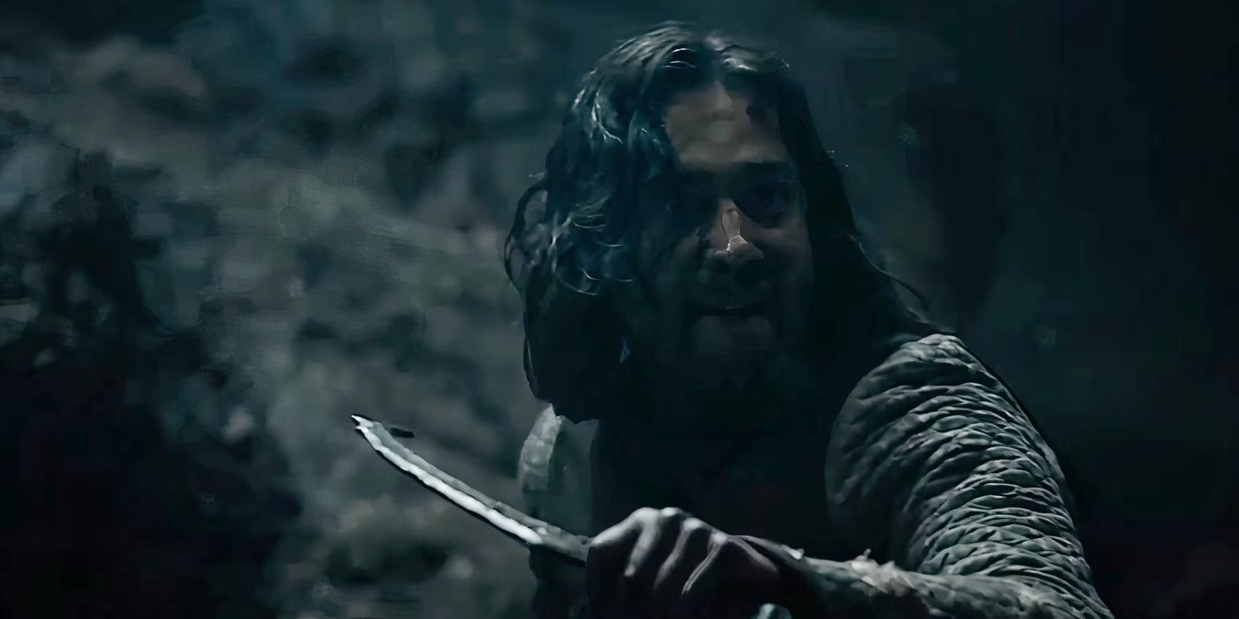 Isildur (Maxim Baldry) with a raised dagger in The Lord of the Rings: The Rings of Power Season 2