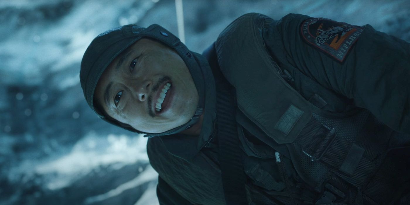 Steven Yeun in winter gear smiling in Mickey 17.