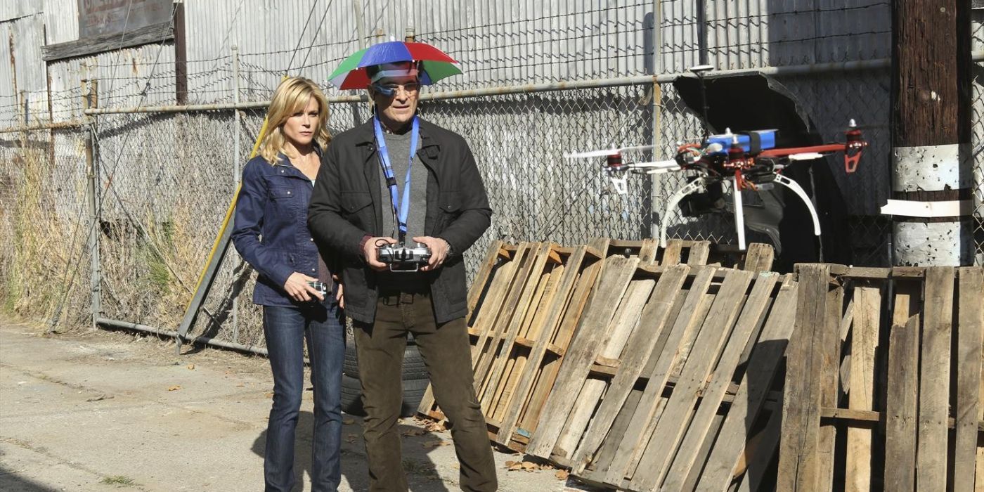 Claire and Phil Dunphy using a drone outside in Modern Family