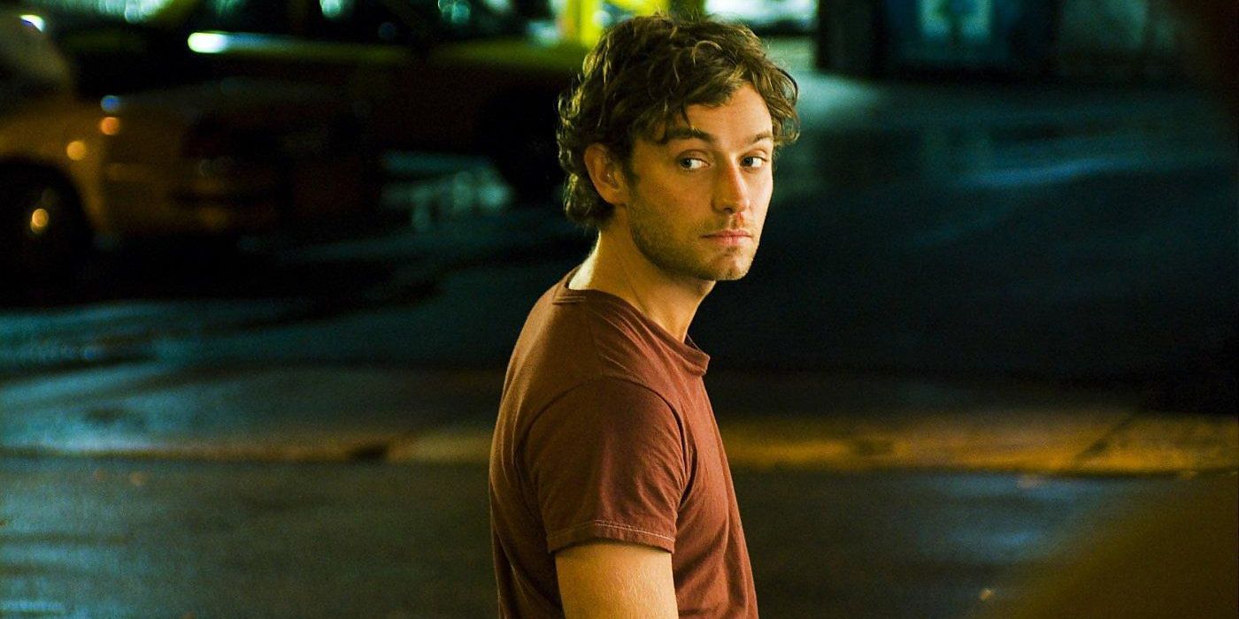 Jude Law looking back at the camera while standing out in the street in My Blueberry Nights.