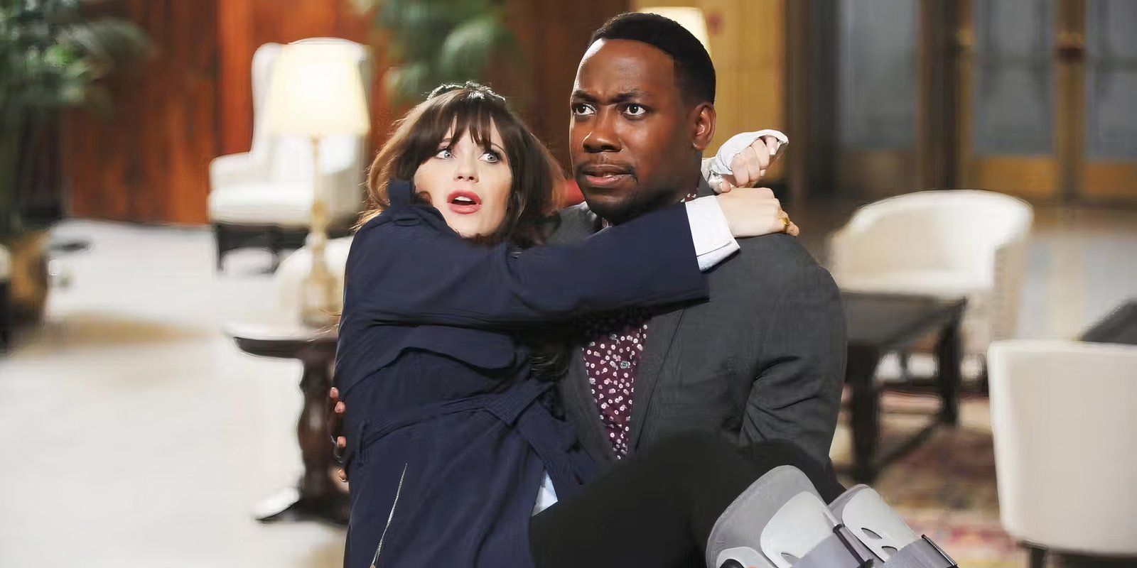 Lamorne Morris as Winston carries Zooey Deschanel as Jess who has braces on both feet in New Girl.