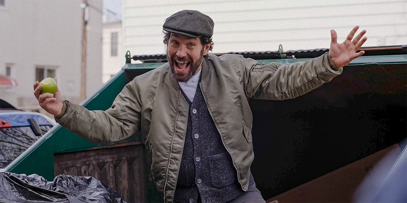 Paul Rudd jumping out of a trashcan with an apple in his hand in Only Murders in the Building